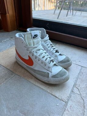 Nike White High-Top Sneakers with Orange Swoosh